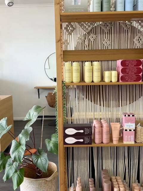 The stocked haircare shelf inside Serenity Hair & Beauty